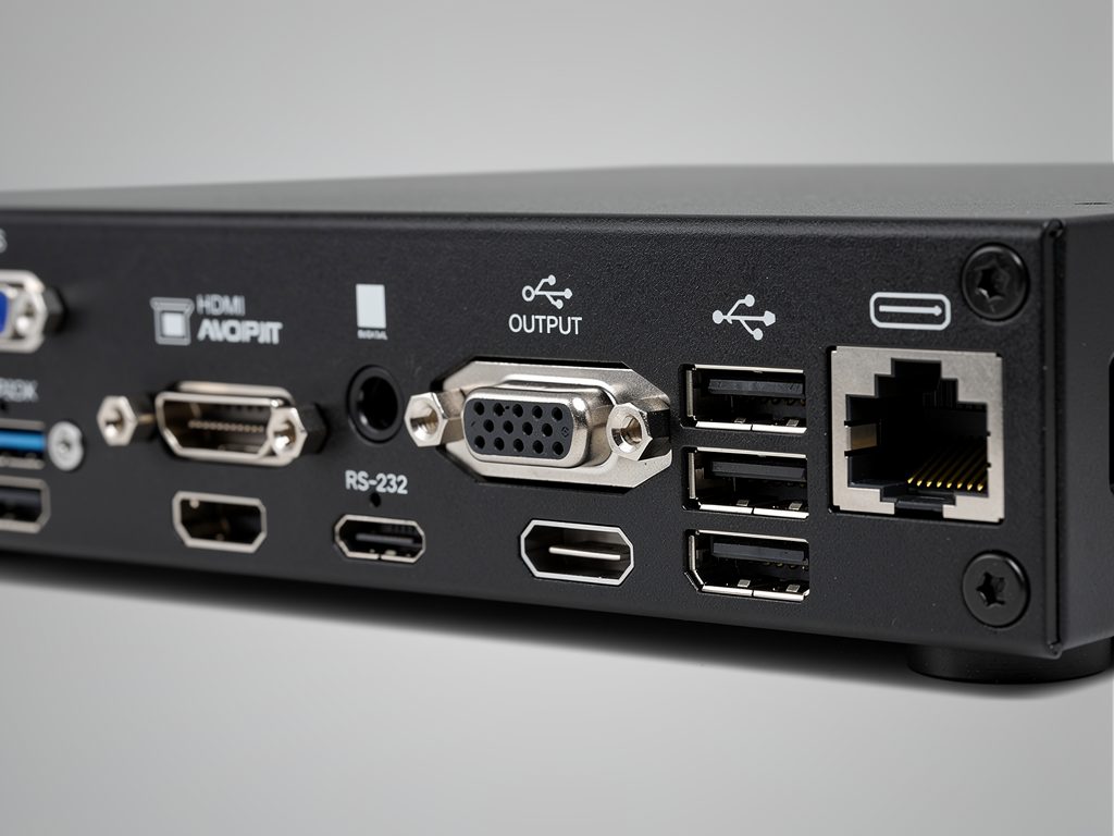 Rear panel of AVoIP decoder showing diverse connectivity options including HDMI output, RS-232 port, USB connections, and Ethernet jack, photographed at slight angle with professional lighting revealing port labels and build quality